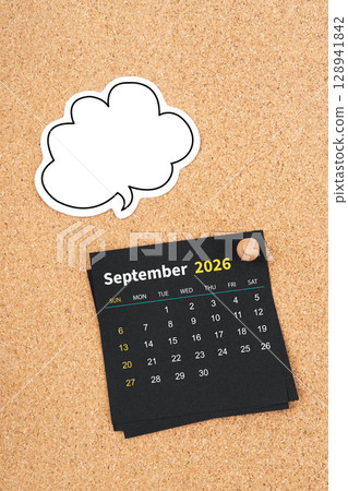 September 2026 Black calendar page and blank speech bubble with thumbtack on wooden board. September 2026 Black calendar page and blank speech bubble with thumbtack on wooden board. 128941842