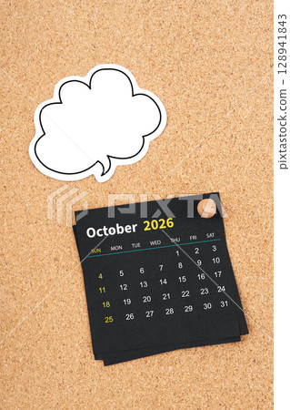 October 2026 Black calendar page and blank speech bubble with thumbtack on wooden board. 128941843