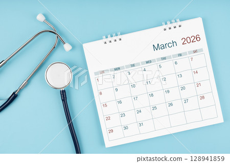 March 2026 desk calendar and stethoscope on blue color, Medical appointment concept. March 2026 desk calendar and stethoscope on blue color, Medical appointment concept. 128941859