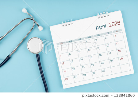 April 2026 desk calendar and stethoscope on blue color, Medical appointment concept. April 2026 desk calendar and stethoscope on blue color, Medical appointment concept. 128941860
