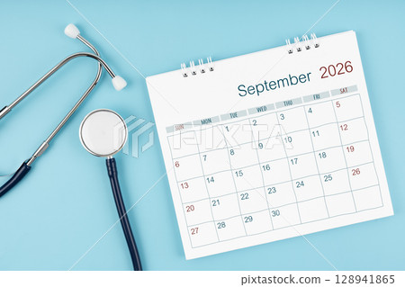 September 2026 desk calendar and stethoscope on blue color, Medical appointment concept. September 2026 desk calendar and stethoscope on blue color, Medical appointment concept. 128941865