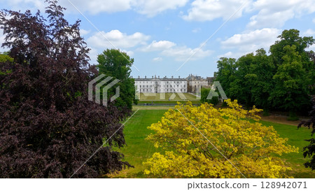 Downing College framed by trees in Cambridge University, UK 128942071