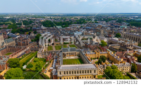 Cambridge University campus and city skyline showing historic buildings and green spaces on sunny Cambridge University campus and city skyline showing historic buildings and green spaces on sunny 128942132