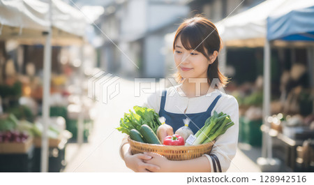 Woman buying vegetables 128942516