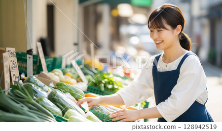 Woman buying vegetables 128942519