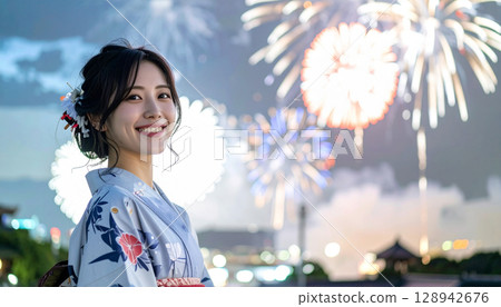 Fireworks in the summer night sky and a smiling woman in a yukata Fireworks in the summer night sky and a smiling woman in a yukata 128942676