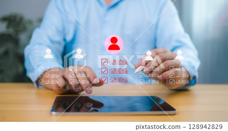 Recruitment process with businessman selecting candidate profile on tablet. Human resource management and AI driven digital hiring concept. 128942829