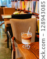 Iced Latte Moment in a Cozy Book Cafe 128943085