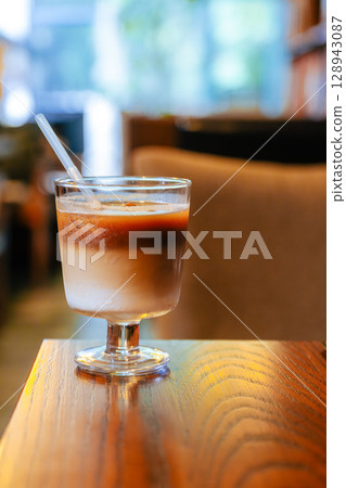 Iced Latte Moment in a Cozy Book Cafe Iced Latte Moment in a Cozy Book Cafe 128943087
