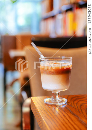 Iced Latte Moment in a Cozy Book Cafe Iced Latte Moment in a Cozy Book Cafe 128943088