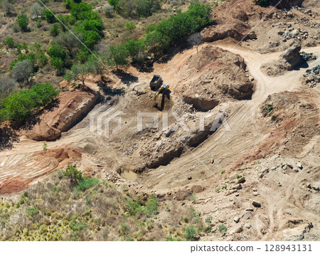 Machines work loading sand from quarry 128943131