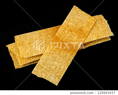Long chips isolated on black background, rectangular mashed potato snacks, package design element 128943437