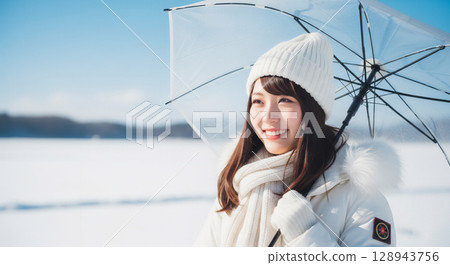 A woman smiling in a winter snow scene 128943756