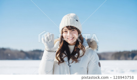 A woman smiling in a winter snow scene 128943758