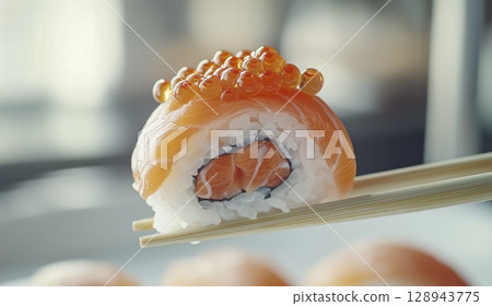 Salmon sushi roll with red caviar held by chopsticks close up, soft background, copy space Salmon sushi roll with red caviar held by chopsticks close up, soft background, copy space 128943775