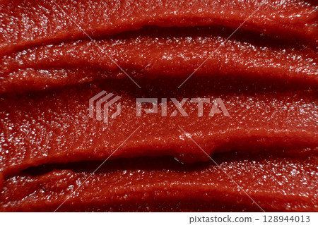 Macro Texture of Rich Tomato Paste. Culinary Red Background. Macro Texture of Rich Tomato Paste. Culinary Red Background. 128944013