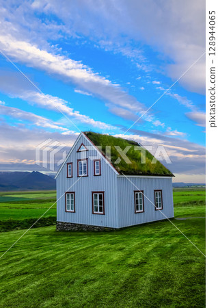 Beautiful wooden house with green roof in Iceland. Beautiful wooden house with green roof in Iceland. 128944065