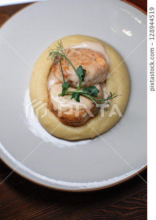 Delicious cutlets with airy mashed potatoes served Delicious cutlets with airy mashed potatoes served 128944519