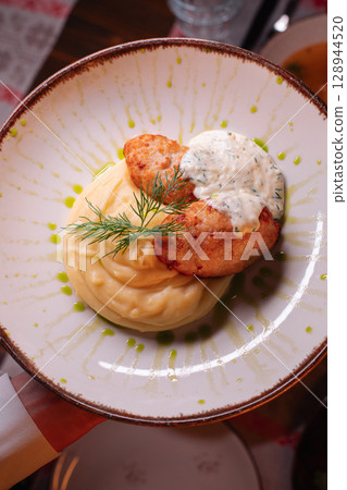 Delicious cutlets with airy mashed potatoes served Delicious cutlets with airy mashed potatoes served 128944520