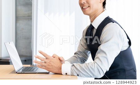 Smiling male businessman having a conversation Smiling male businessman having a conversation 128944923