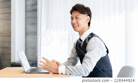 Smiling male businessman having a conversation 128944924