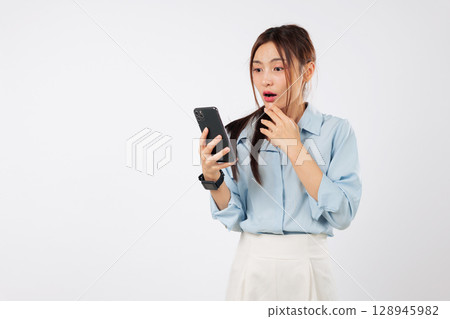 Asian phone woman worry sad surprise unhappy with mouth open in shock, sees frustrating mobile problems, experiences a technological shocked, reads bad news on phone, isolated studio white background 128945982