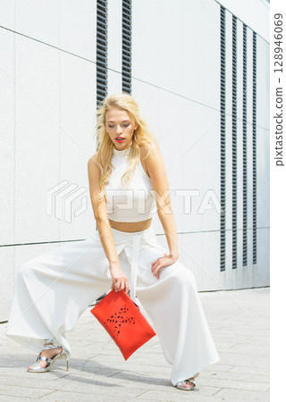 Fashion woman white outfit with red handbag Fashion woman white outfit with red handbag 128946069