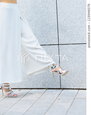 Woman wearing high heels and culottes Woman wearing high heels and culottes 128946076