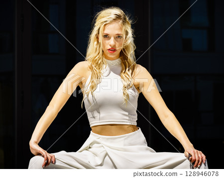 Woman wearing crop top and culottes Woman wearing crop top and culottes 128946078