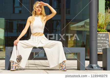 Woman wearing crop top and culottes Woman wearing crop top and culottes 128946079