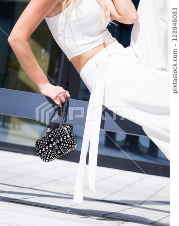 Woman wearing crop top and culottes Woman wearing crop top and culottes 128946083