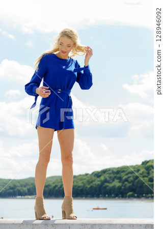 Fashion model wearing blue jumpsuit Fashion model wearing blue jumpsuit 128946092