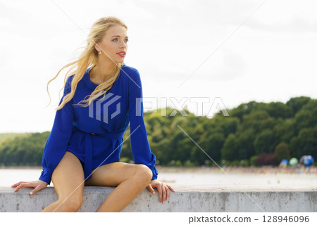 Fashion model wearing blue jumpsuit 128946096