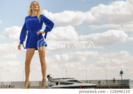Fashion model wearing blue jumpsuit Fashion model wearing blue jumpsuit 128946110