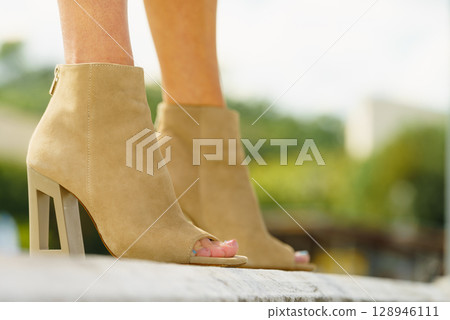 Woman wearing suede brown high heels 128946111