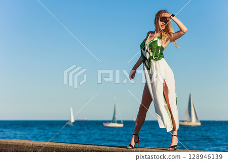 Fashion woman against sea. 128946139