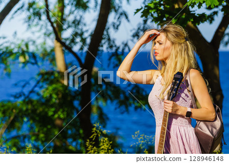 Girl with guitar outdoor on nature Girl with guitar outdoor on nature 128946148