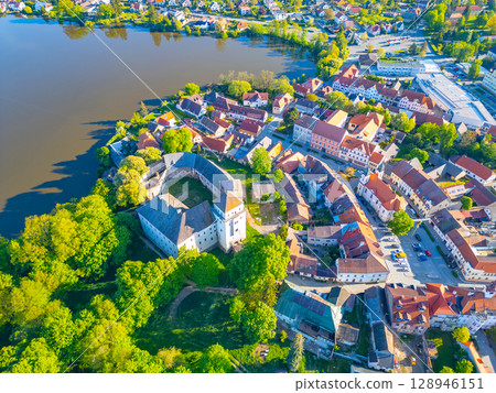 The charming town of Rozmital pod Tremsinem showcases its historic castle surrounded by lush greenery and tranquil waters, blending natural beauty with cultural heritage. The charming town of Rozmital pod Tremsinem showcases its historic castle surrounded by lush greenery and tranquil waters, blending natural beauty with cultural heritage. 128946151