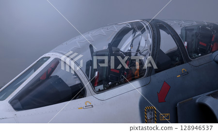 Close up of modern aircraft military fighter jet. Close up Jet parts such as landing gear engine nacelles weapon pods and cockpit with visible pilots showing defense technology and aircraft design. Close up of modern aircraft military fighter jet. Close up Jet parts such as landing gear engine nacelles weapon pods and cockpit with visible pilots showing defense technology and aircraft design. 128946537