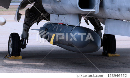 Close up of modern aircraft military fighter jet. Close up Jet parts such as landing gear engine nacelles weapon pods and cockpit with visible pilots showing defense technology and aircraft design. Close up of modern aircraft military fighter jet. Close up Jet parts such as landing gear engine nacelles weapon pods and cockpit with visible pilots showing defense technology and aircraft design. 128946552