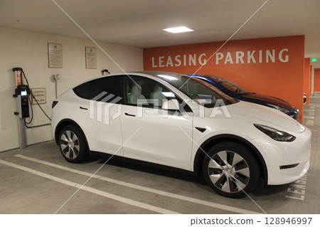 A display scene at an American car dealership with a wide selection of popular models: Ford, Chevrolet, Dutch, pickup trucks, A display scene at an American car dealership with a wide selection of popular models: Ford, Chevrolet, Dutch, pickup trucks, 128946997