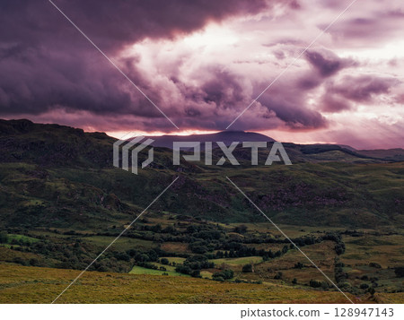 Overcast landscape view of the irish Coomloughra Horseshoe mountains with moody lighting. Overcast landscape view of the irish Coomloughra Horseshoe mountains with moody lighting. 128947143