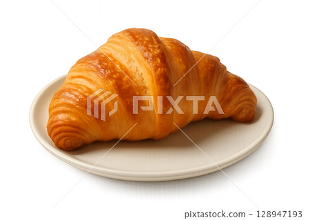 Freshly Baked Buttery Croissant Served on a White Plate in a Cozy Kitchen Setting During Breakfast Time 128947193