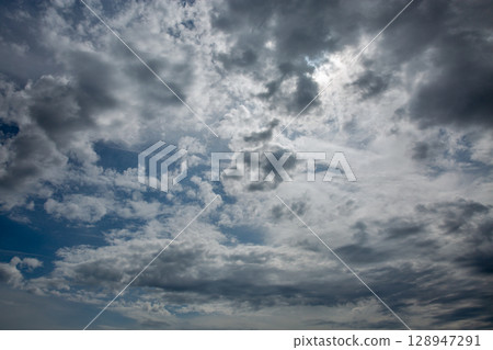 Dramatic storm clouds formation in moody sky 128947291