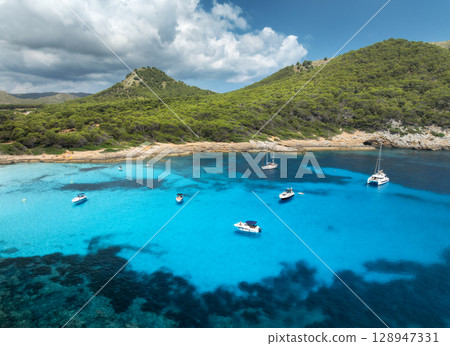 Aerial view of luxury yachts and speed boats on blue sea 128947331