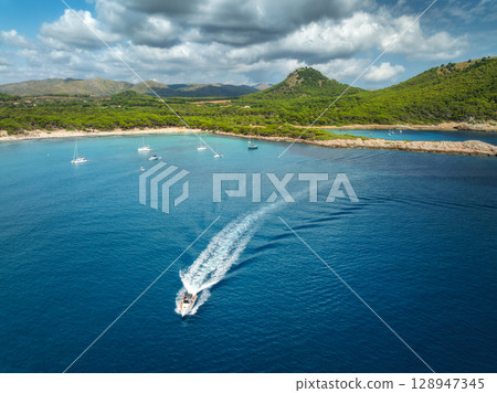Aerial view of luxury yachts and speed boats on blue sea 128947345