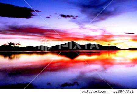 Red sunset dramatic sky reflection in the lake. Red sunset dramatic sky reflection in the lake. 128947381