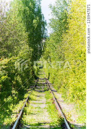 Railway rails going into the distance. Railway rails and sleepers close-up. Railway rails going into the distance. Railway rails and sleepers close-up. 128947871