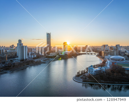 Yekaterinburg aerial panoramic view in spring at sunset. Yekaterinburg city and pond in spring or autumn. 128947949