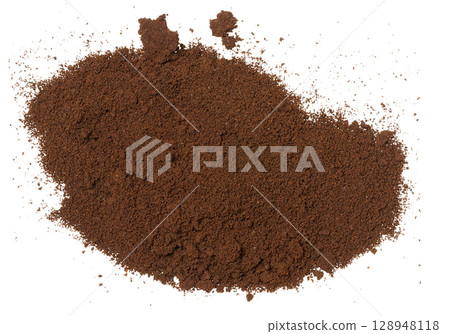 A pile of dark brown finely ground coffee, top view. Coffee is scattered on an isolated background. 128948118